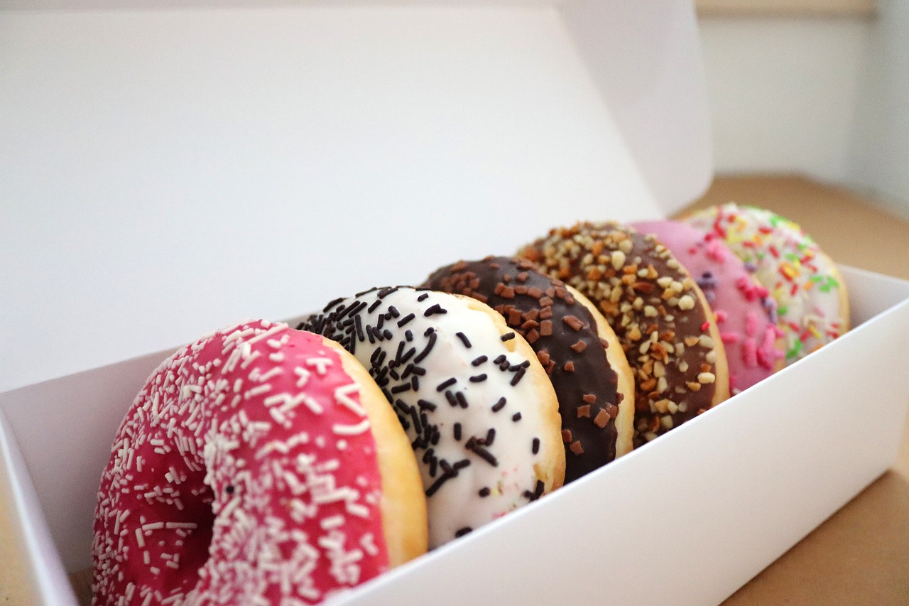 a colourful assortment of donuts in a box
