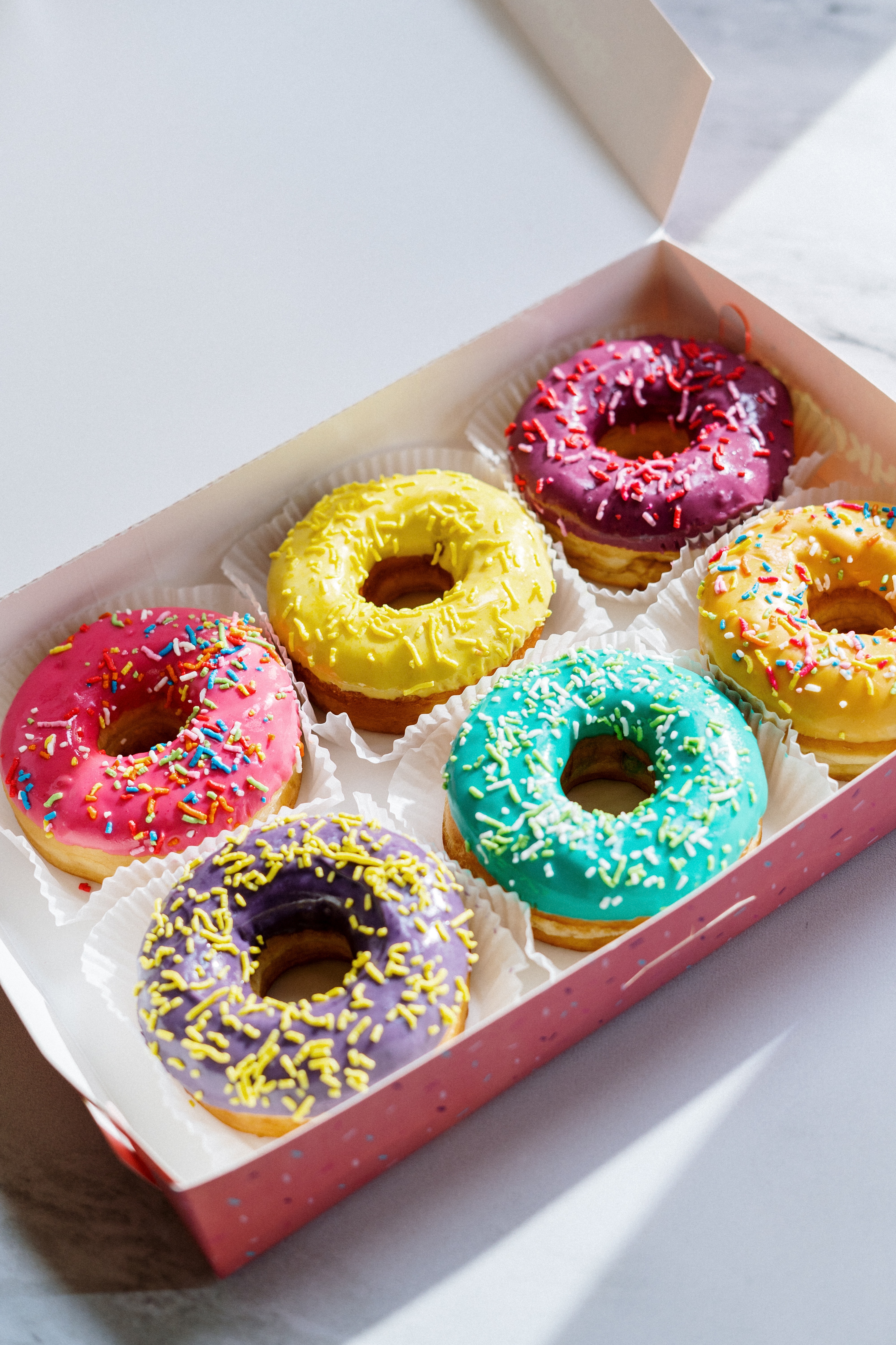 a donut box with 6 different vegan donuts